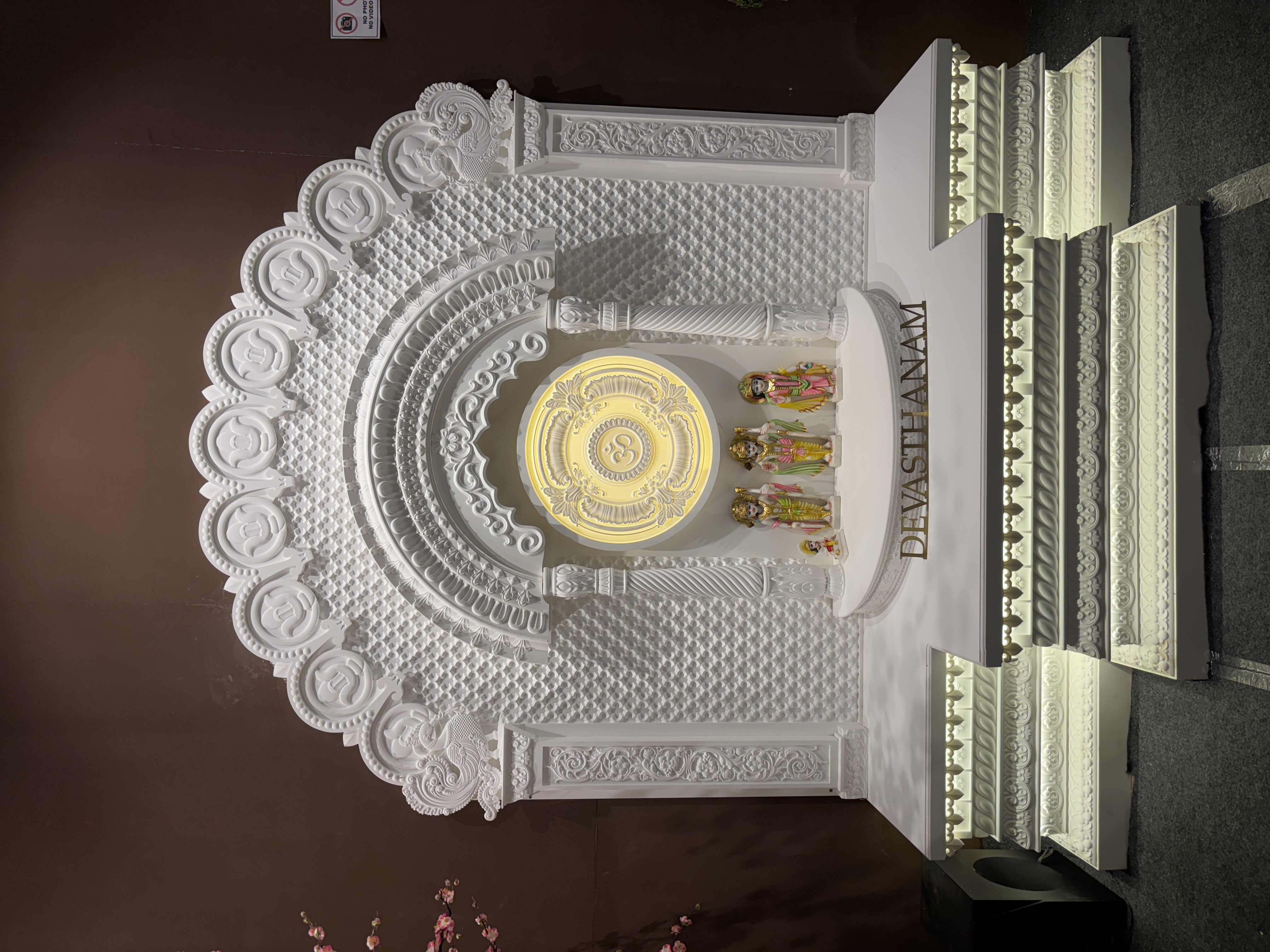 Large white ornate Corian Mandir